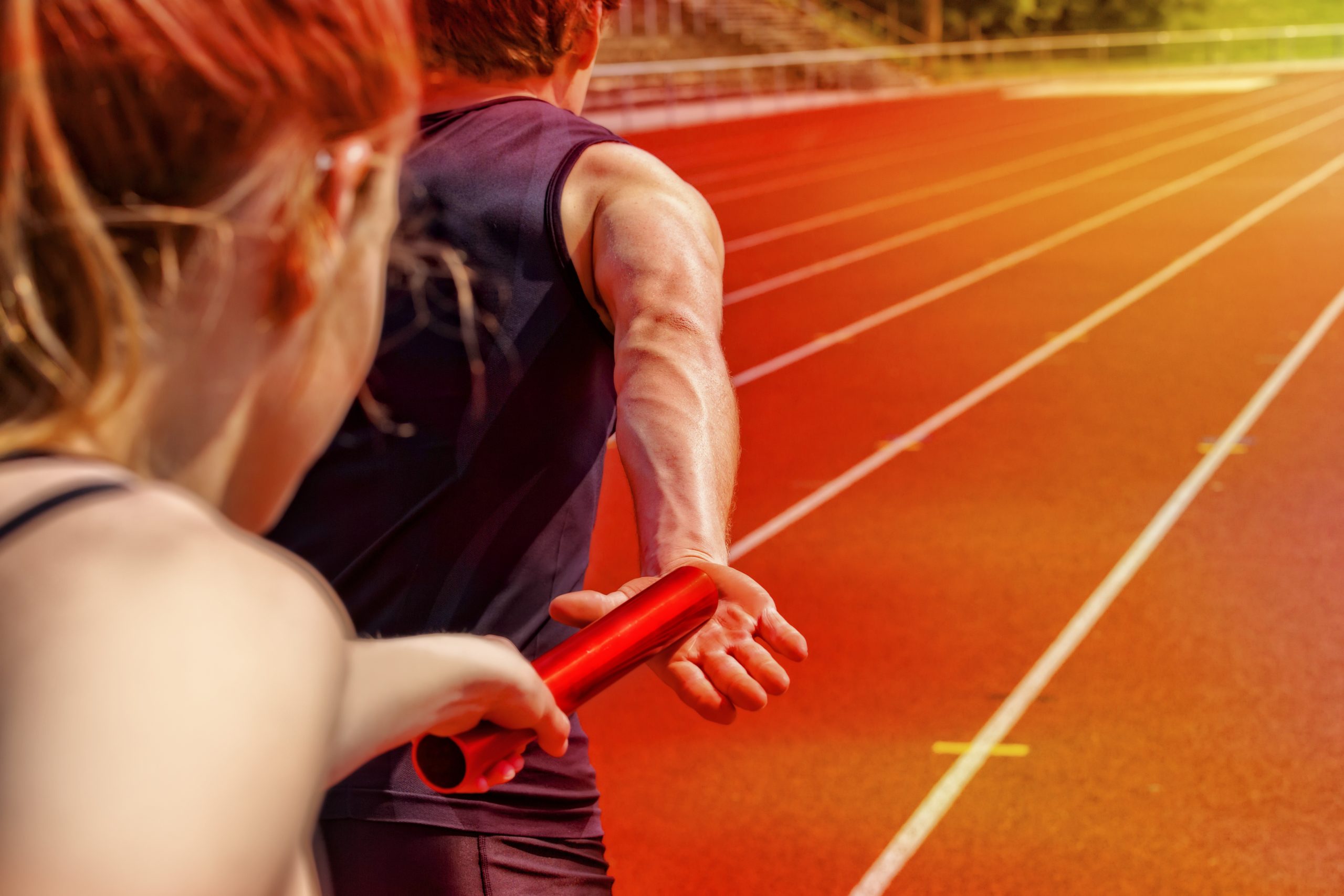 Relay race handing over from woman to man